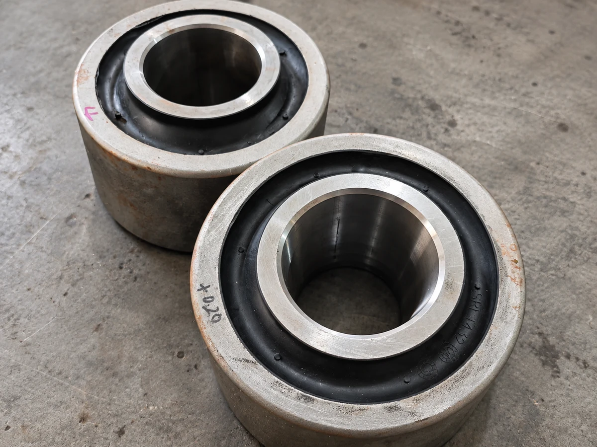 Two components with inner and outer metal sleeves and black rubber between them