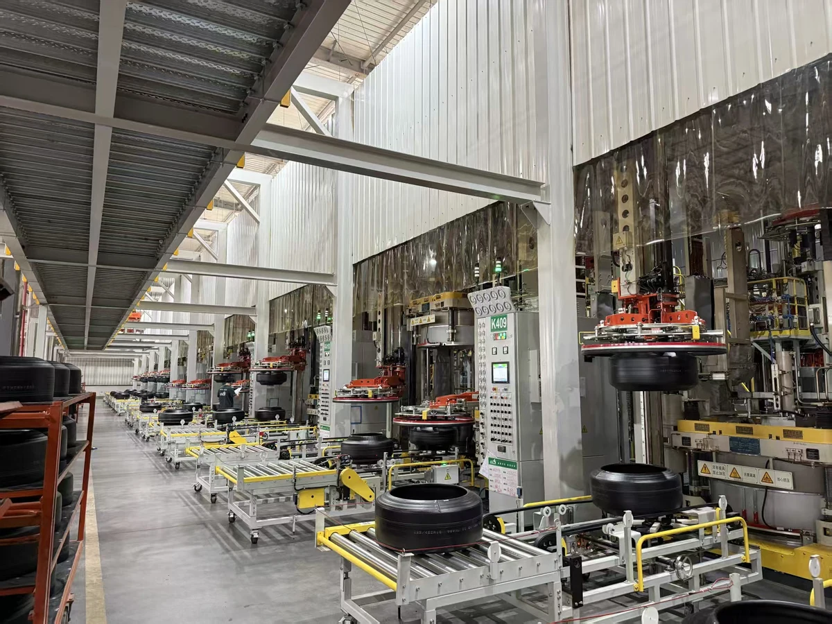 Tires and industrial equipment arranged along a factory aisle