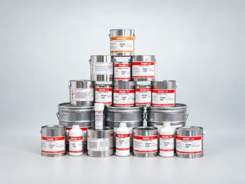 Industrial product cans and bottles displayed together on a table